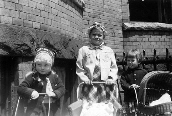 Dear Grandma,
Here I am on the extreme left in my red Norwegian hat with my two playmates.
All my love, Baby Suzanne
1950